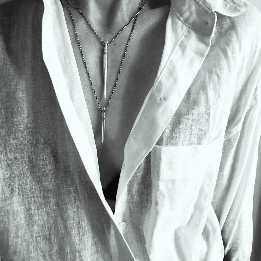 Gladius Sword Necklace in Silver on model in shirt layered