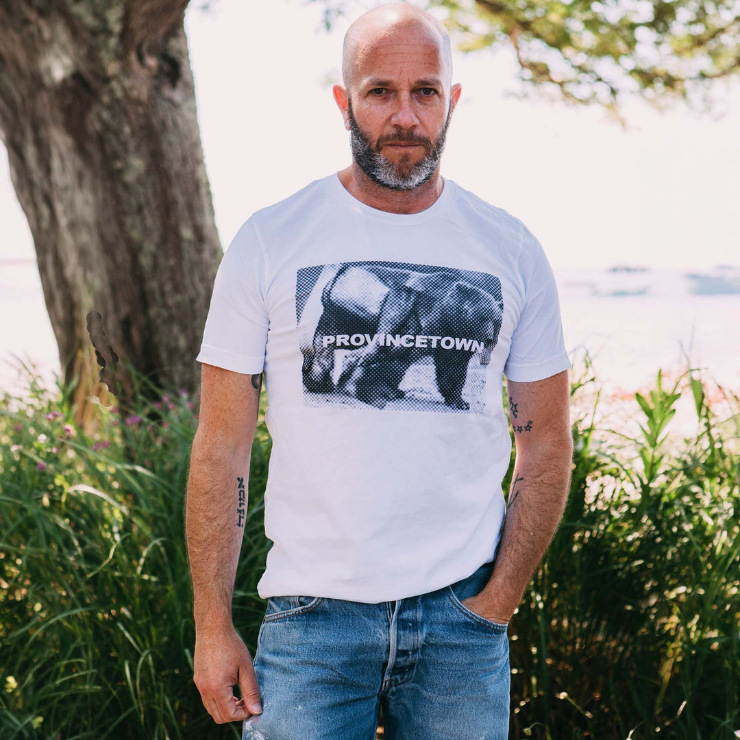 Adam Singer wearing white Naro Pinosa Provincetown bear t-shirt. Bear Week graphic tee from Adam&