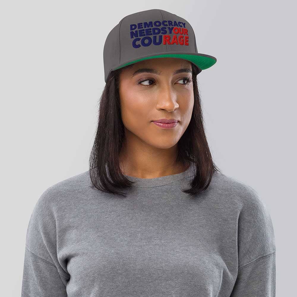 Person wearing a cap with &