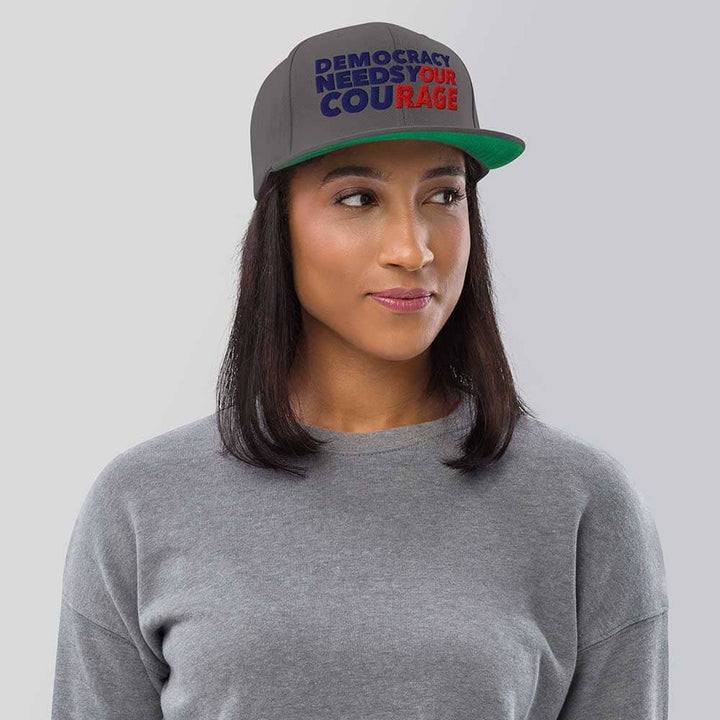 Person wearing a cap with &