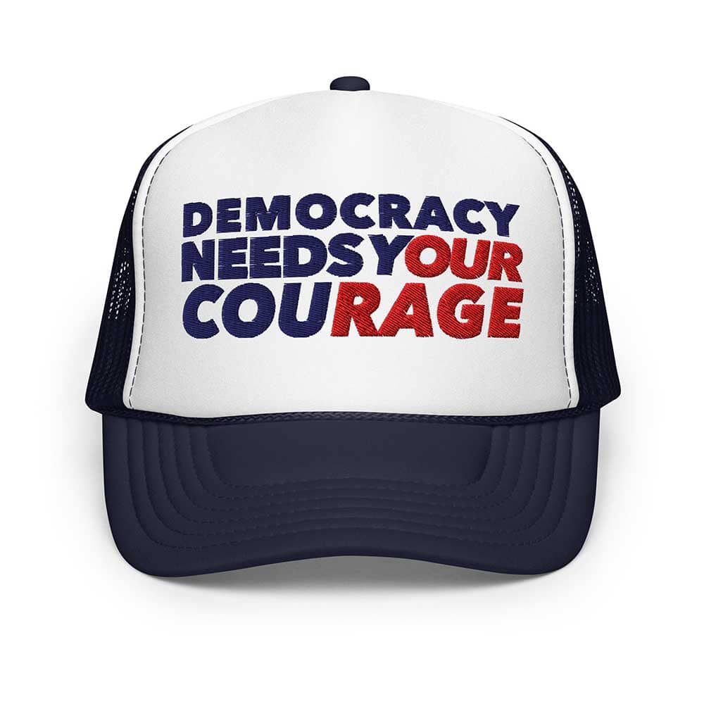 Trucker hat with 'Democracy Needs Your Courage' text on a white background