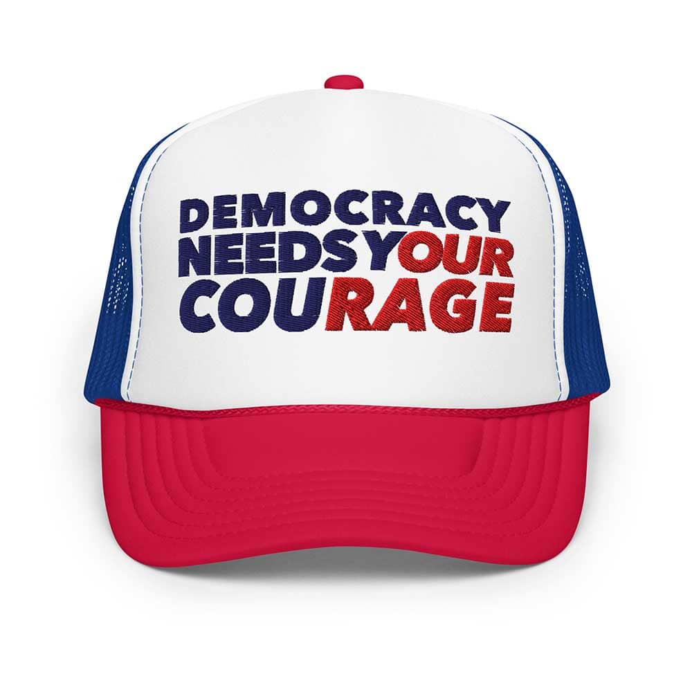Trucker hat with 'Democracy Needs Your Courage' text on a white background