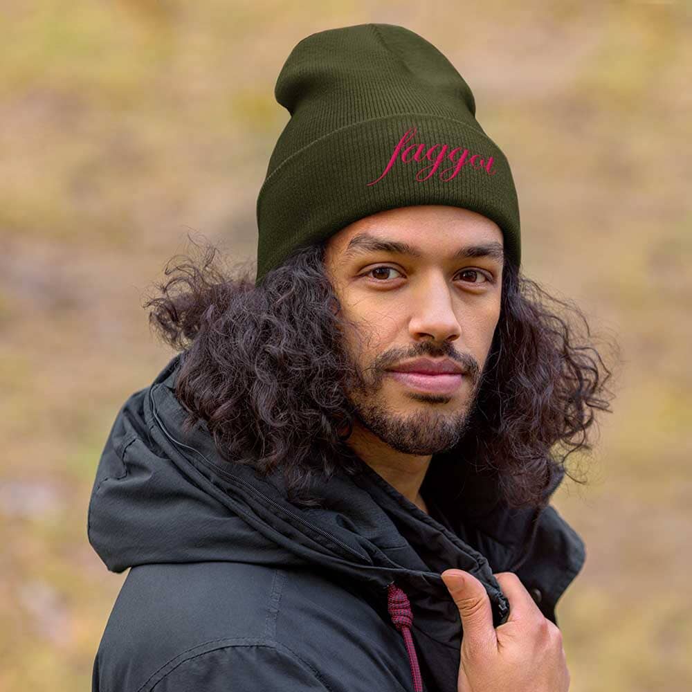 Person wearing a green beanie with &