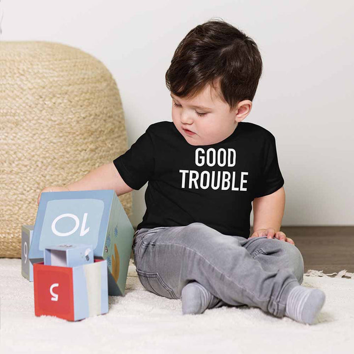 Child wearing a black t-shirt with &