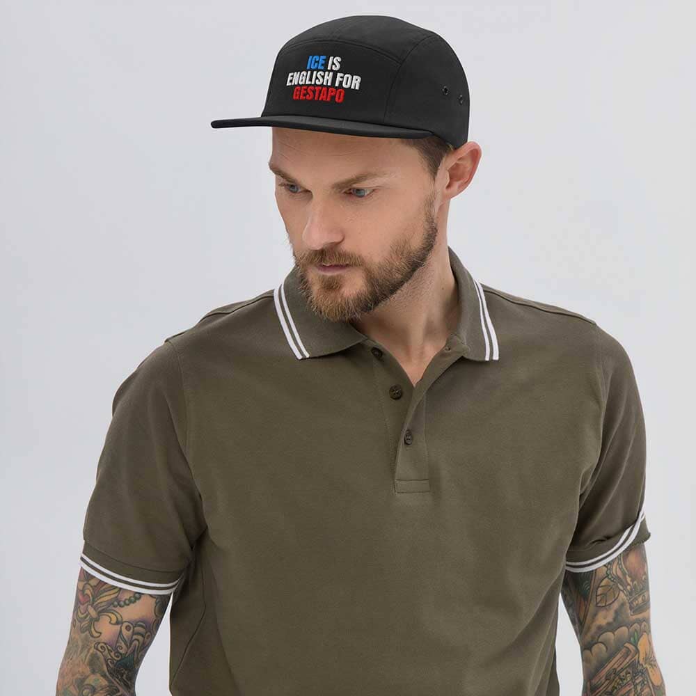 Man wearing a green polo shirt and black cap with text on a gray background