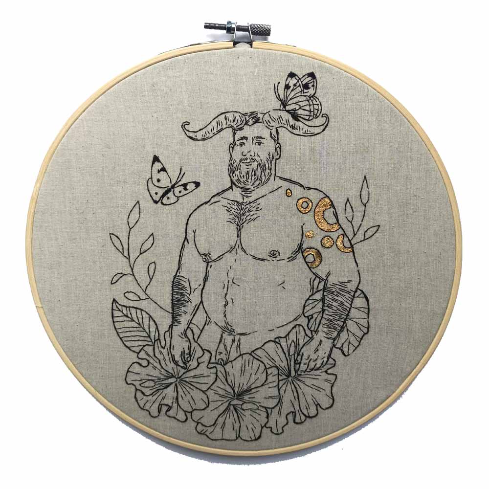 Horned beefy man with gold tattoo embroidery.