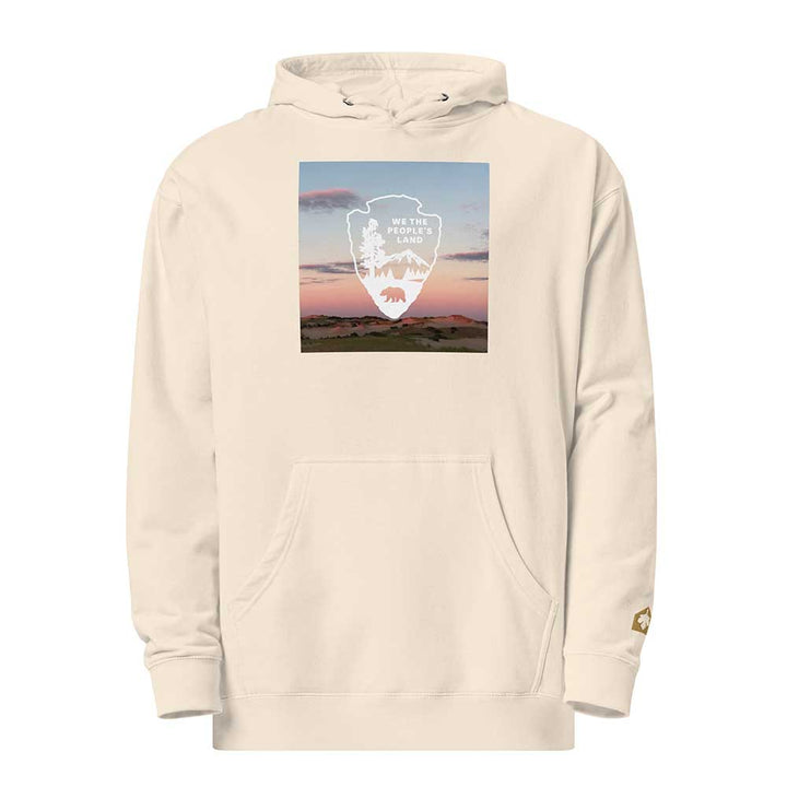 Beige hoodie with a graphic of a mountain and bear design on a white background