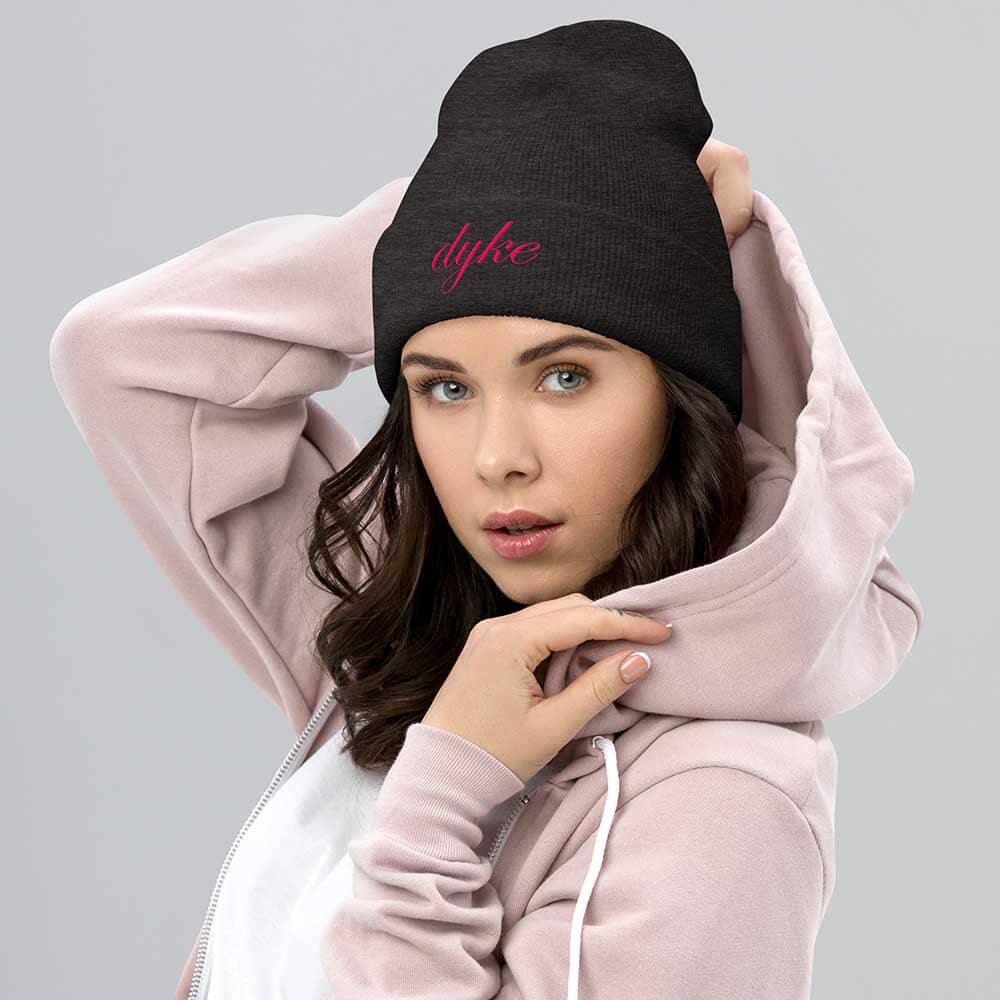 Woman wearing a charcoal grey beanie with &