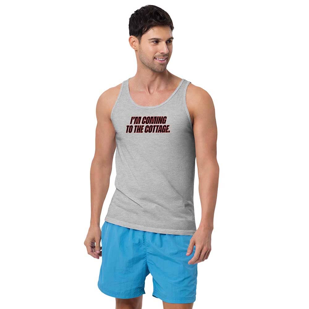 Man wearing a gray tank top with text and blue shorts on a white background