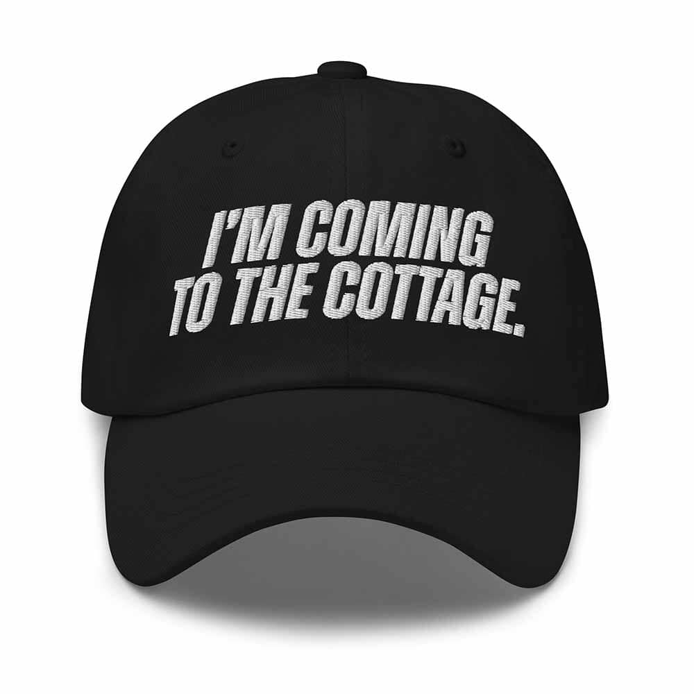 Black cap with 'I'm Coming to the Cottage' text on a white background