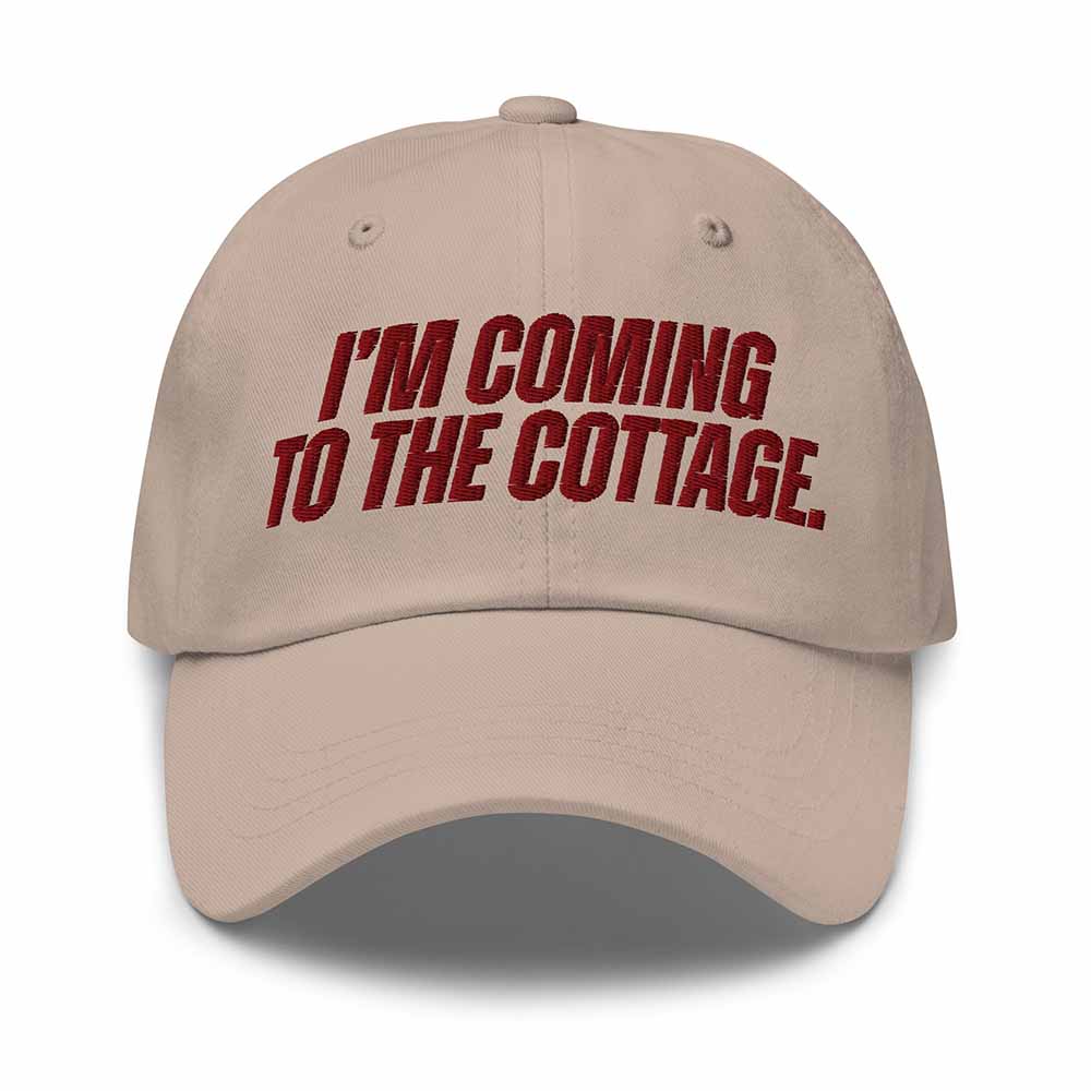 Beige cap with red text 'I'm Coming to the Cottage' on a white background