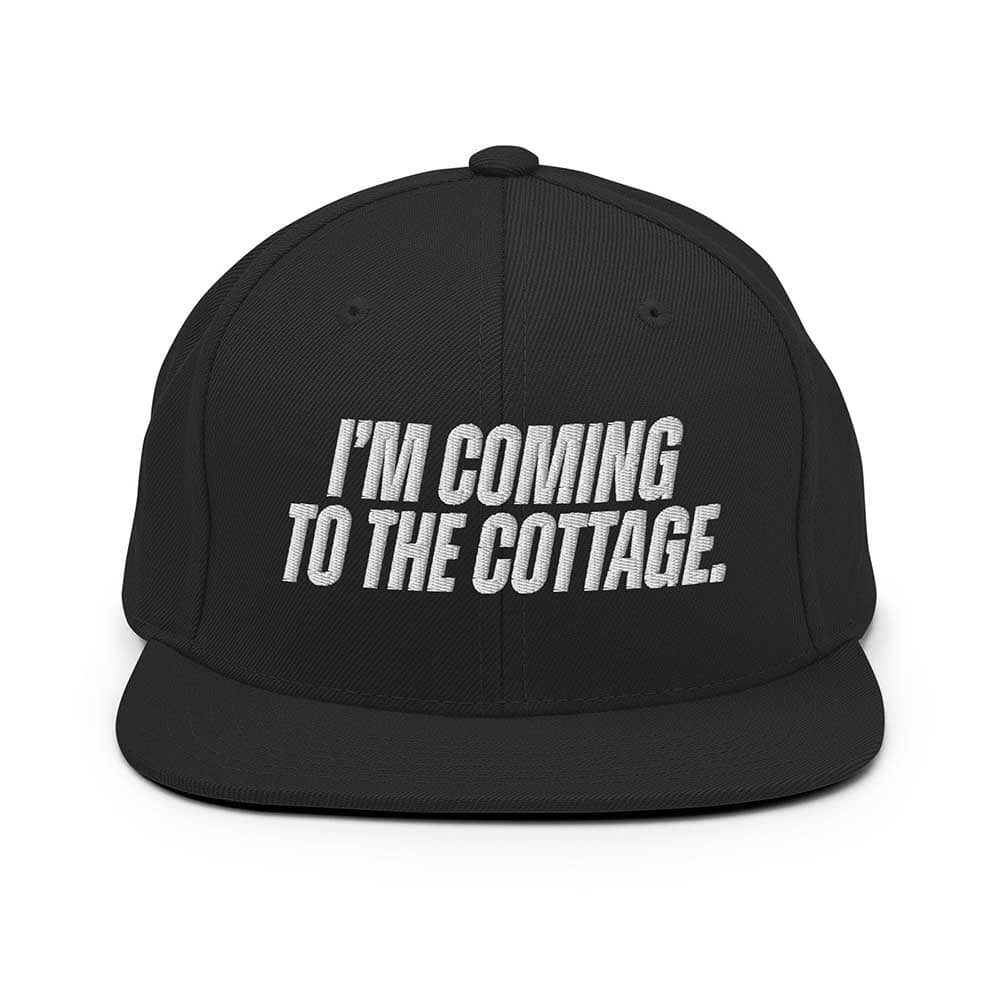 Black cap with white text 'I'm Coming to the Cottage' on a white background