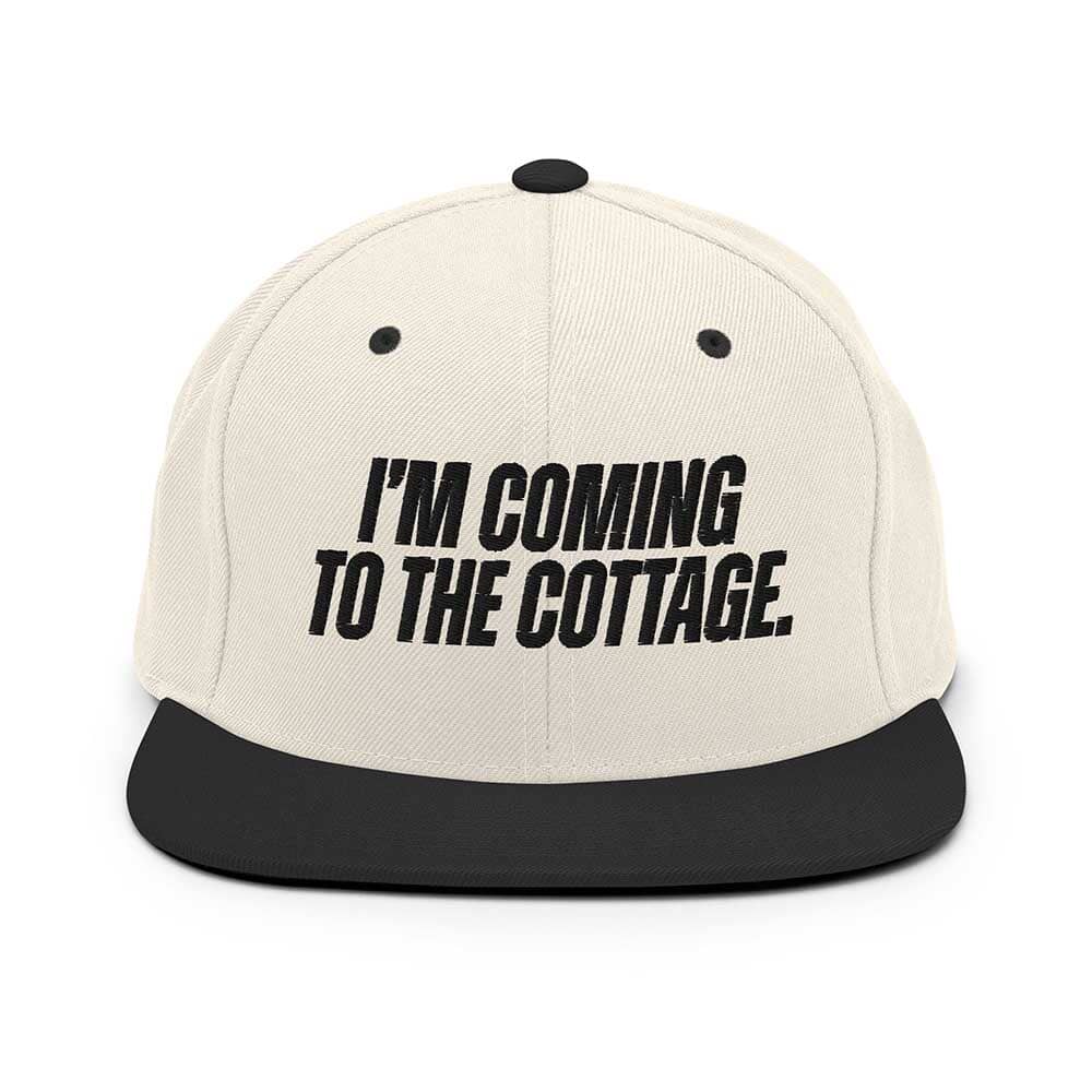 Beige cap with black text 'I'm Coming to the Cottage' on a white background