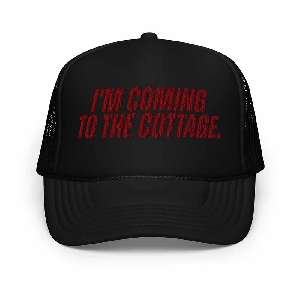 Black trucker hat with red text 'I'm Coming to the Cottage' on a white background