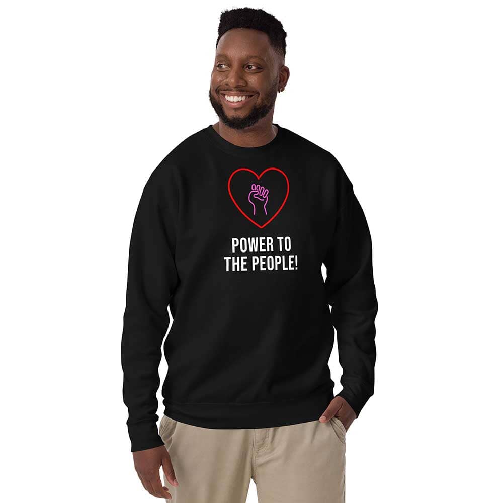 Person wearing a black sweatshirt with a heart and fist design, text &
