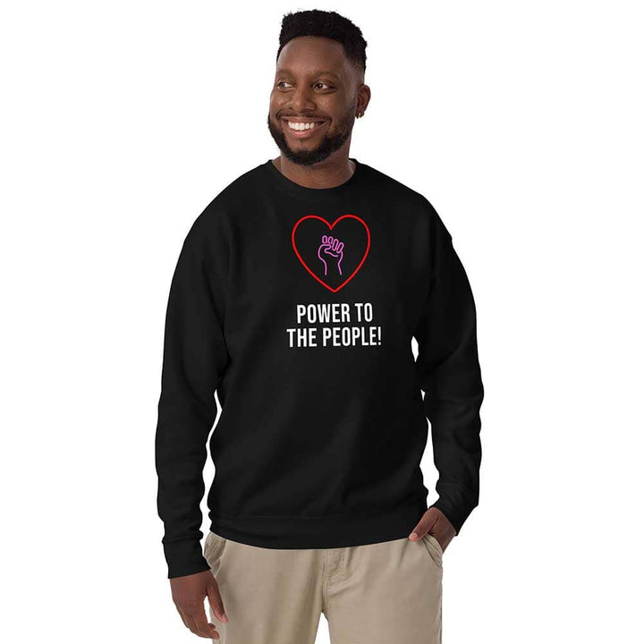Person wearing a black sweatshirt with a heart and fist design, text &