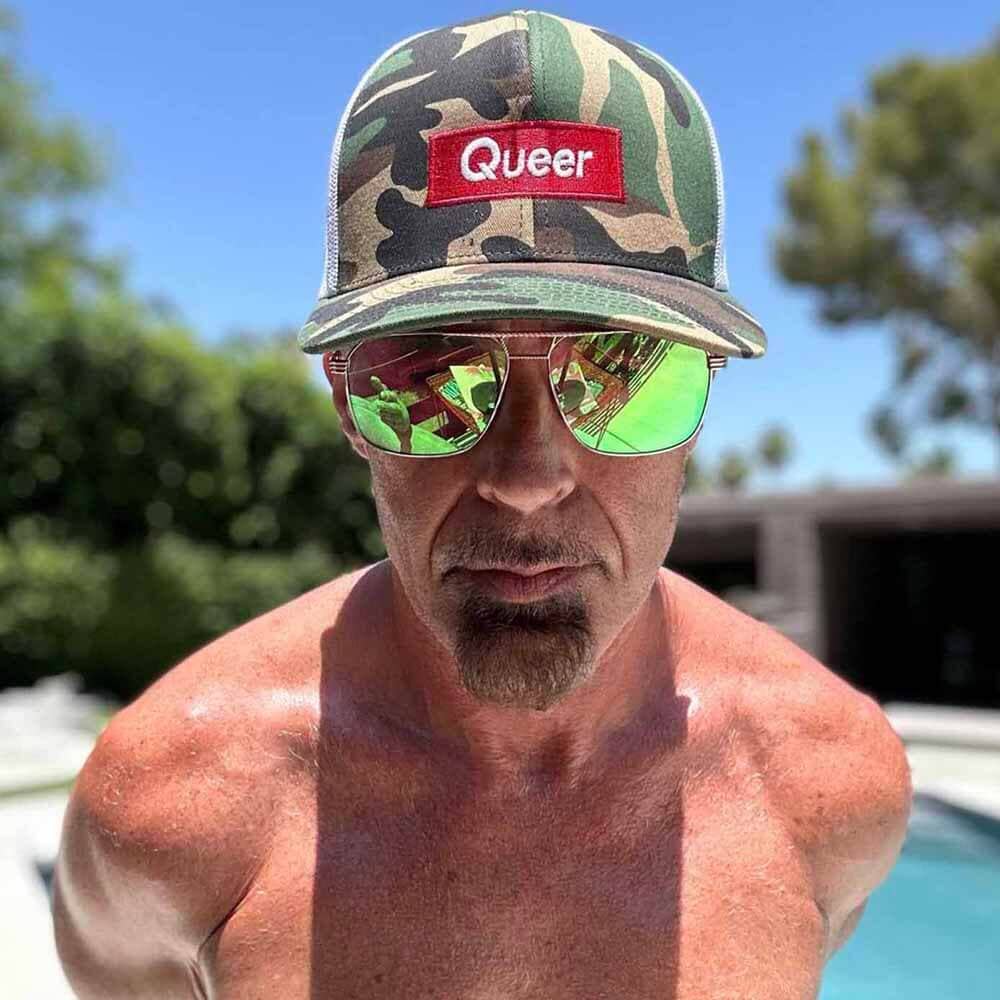 queer camo snapback on man in palm springs pool