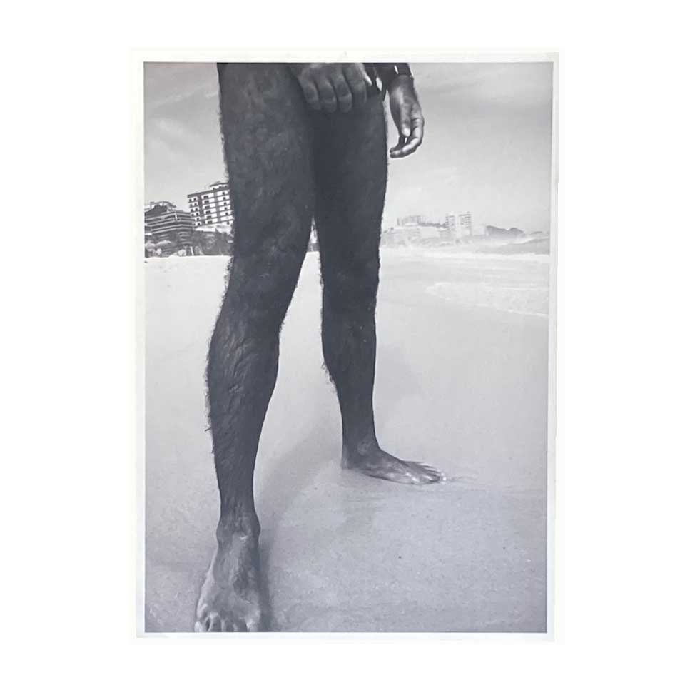 photograph of hairy legs on beach