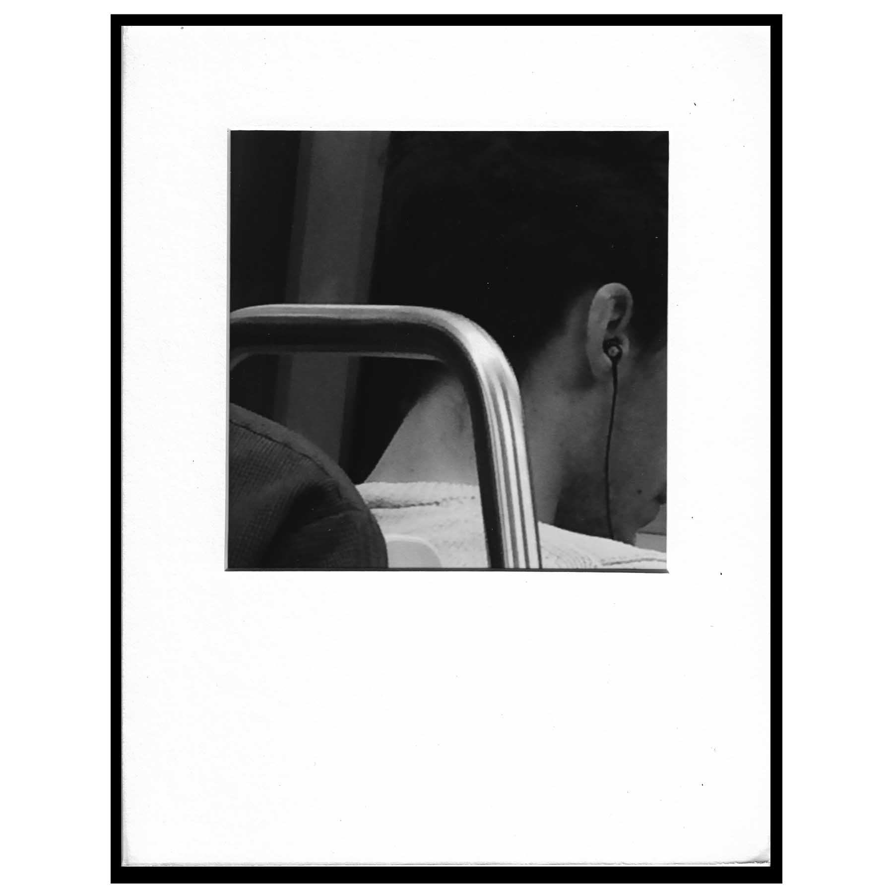 black and white photograph on metro ear bud neck nape