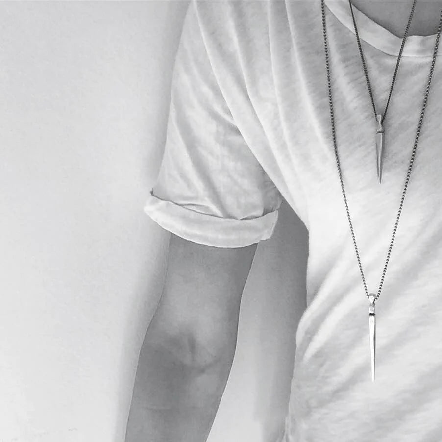 Gladius Sword Necklace in Silver on model in t-shirt layered